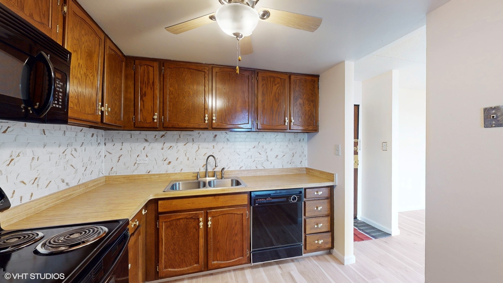 2005 South Finley Road, Unit 805 Lombard, IL 60148 - Photo 13 of 34 a kitchen with a sink stove and microwave