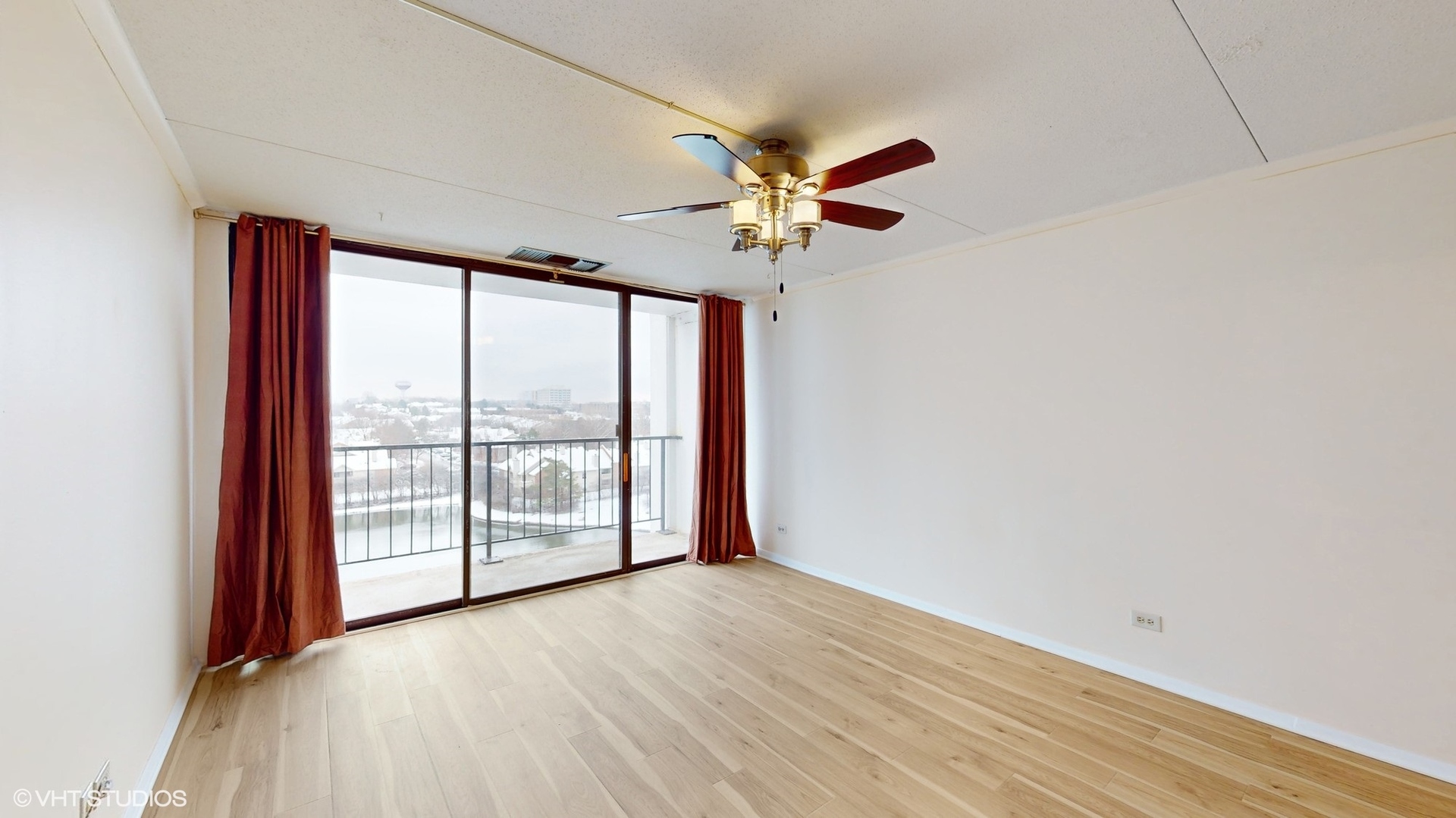 2005 South Finley Road, Unit 805 Lombard, IL 60148 - Photo 16 of 34 an empty room with wooden floor and windows with curtains