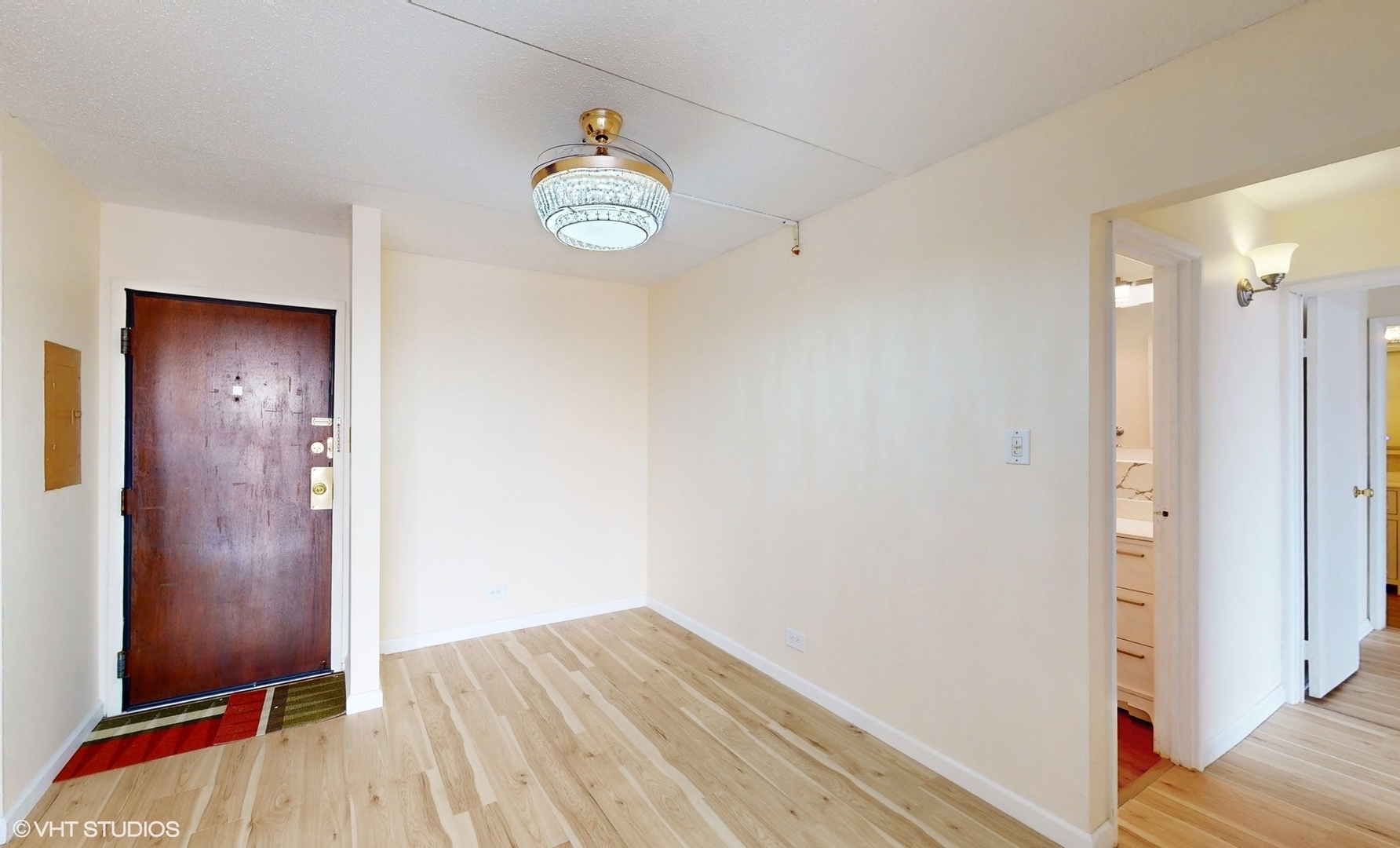 2005 South Finley Road, Unit 805 Lombard, IL 60148 - Photo 7 of 34 an empty room with wooden floor and hallway