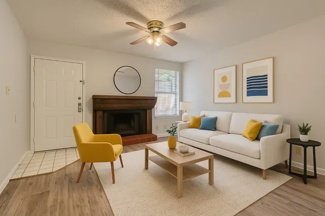 a living room with furniture a fireplace and a table