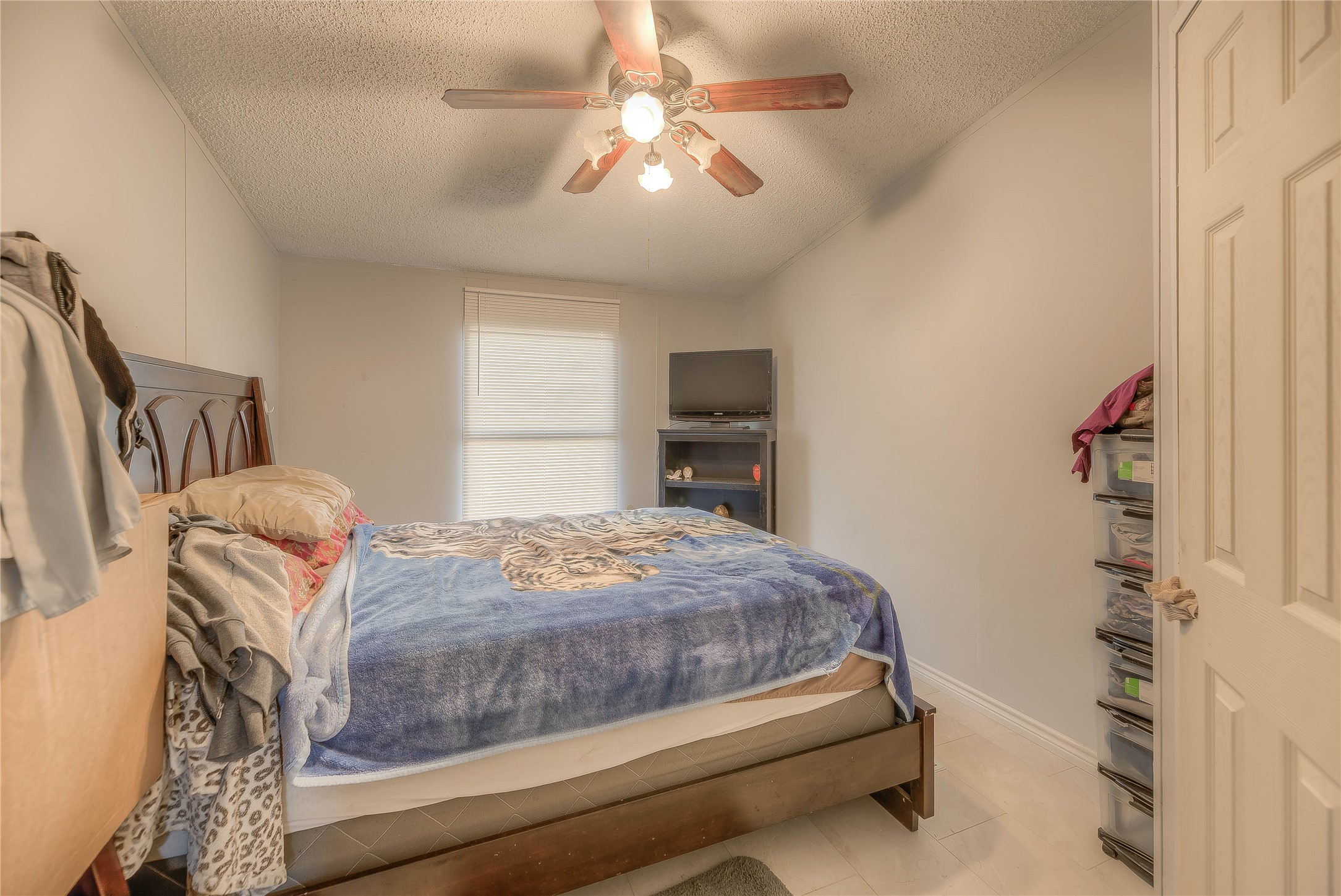 17709 Pine View Drive Conroe, TX 77302 - Photo 16 of 26 a bedroom with a bed and a chandelier