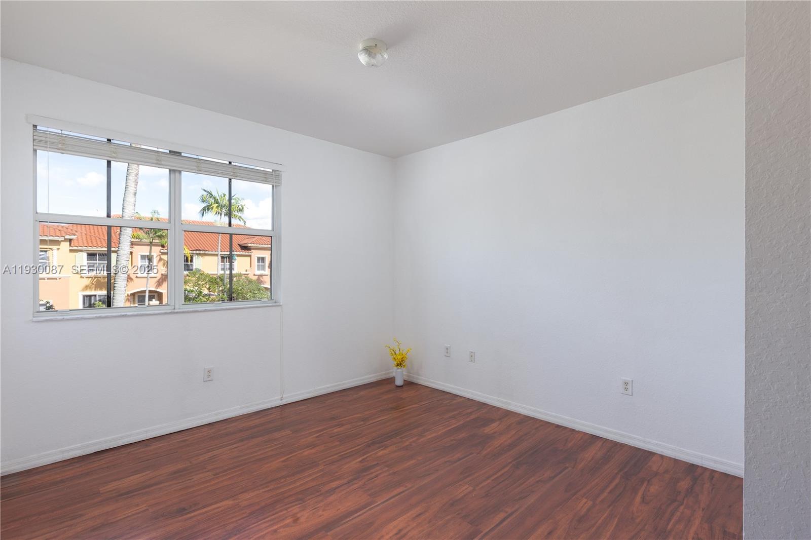 1009 Southwest 144th Avenue, Unit 2701 Pembroke Pines, FL 33027 - Photo 11 of 36 a view of empty room with wooden floor and fan
