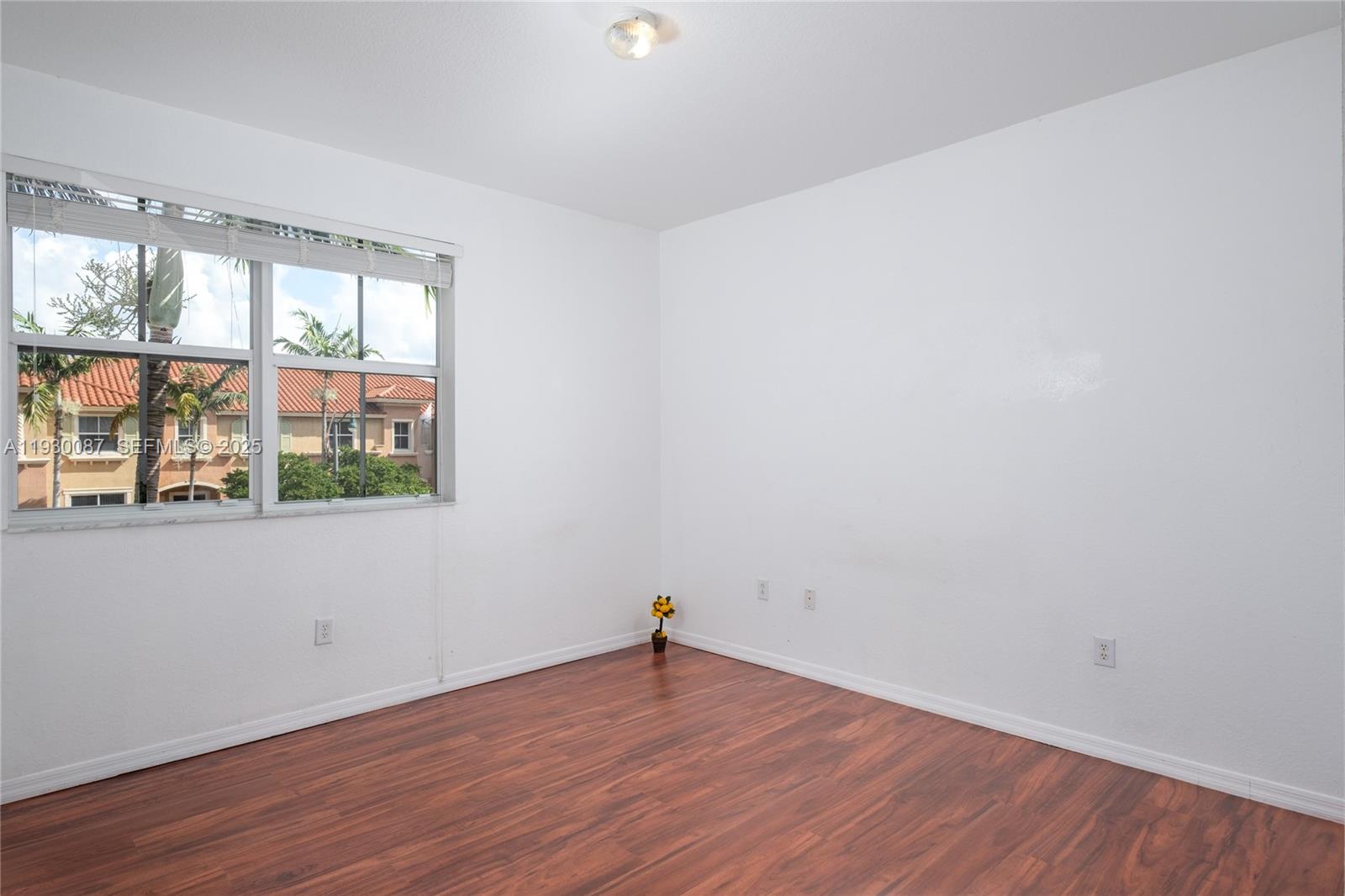 1009 Southwest 144th Avenue, Unit 2701 Pembroke Pines, FL 33027 - Photo 12 of 36 wooden floor in an empty room with a window