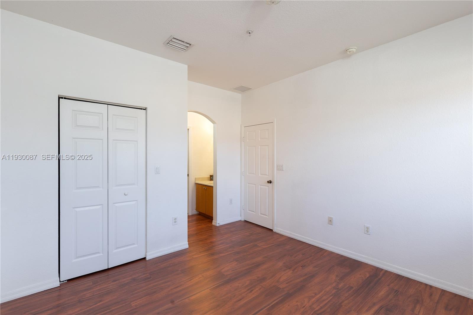 1009 Southwest 144th Avenue, Unit 2701 Pembroke Pines, FL 33027 - Photo 13 of 36 a view of an empty room with wooden floor