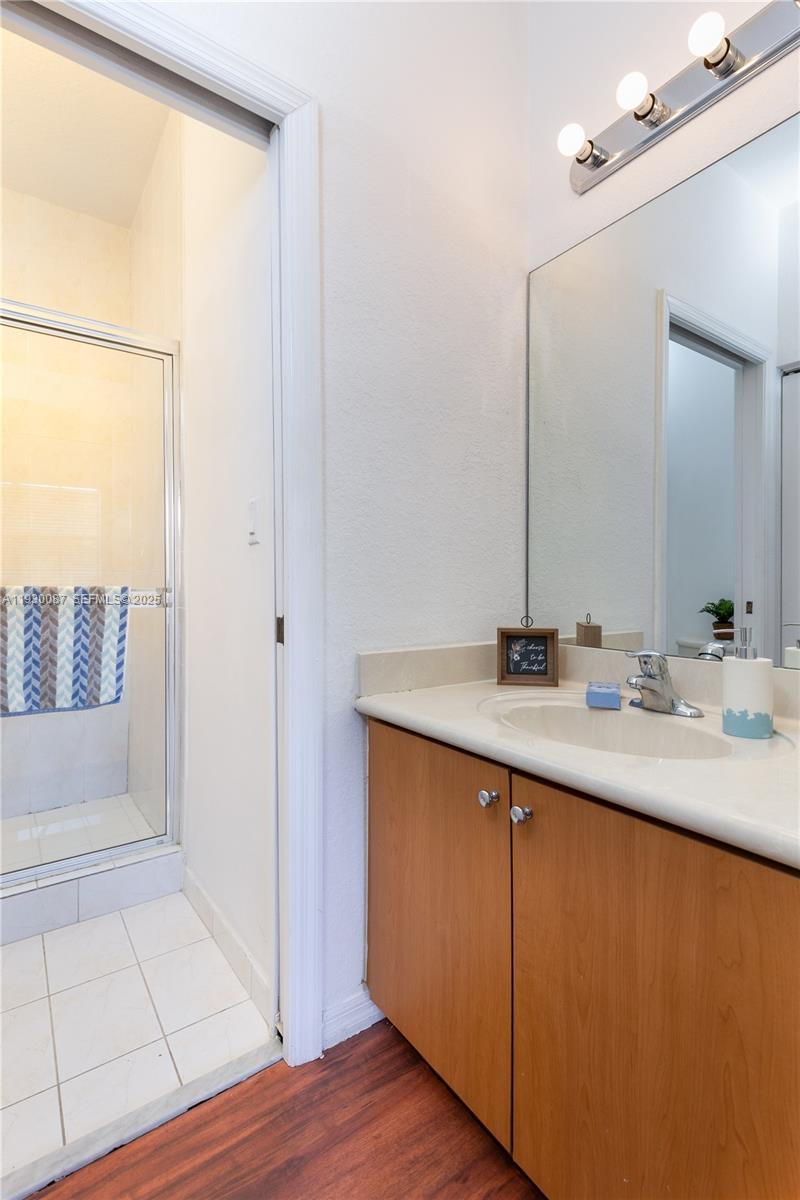 1009 Southwest 144th Avenue, Unit 2701 Pembroke Pines, FL 33027 - Photo 14 of 36 a bathroom with a sink and a mirror