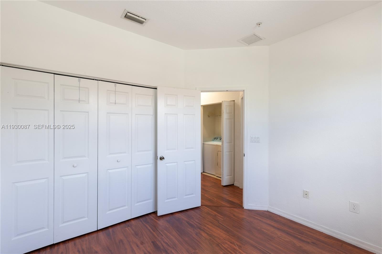 1009 Southwest 144th Avenue, Unit 2701 Pembroke Pines, FL 33027 - Photo 17 of 36 a view of an empty room with wooden floor