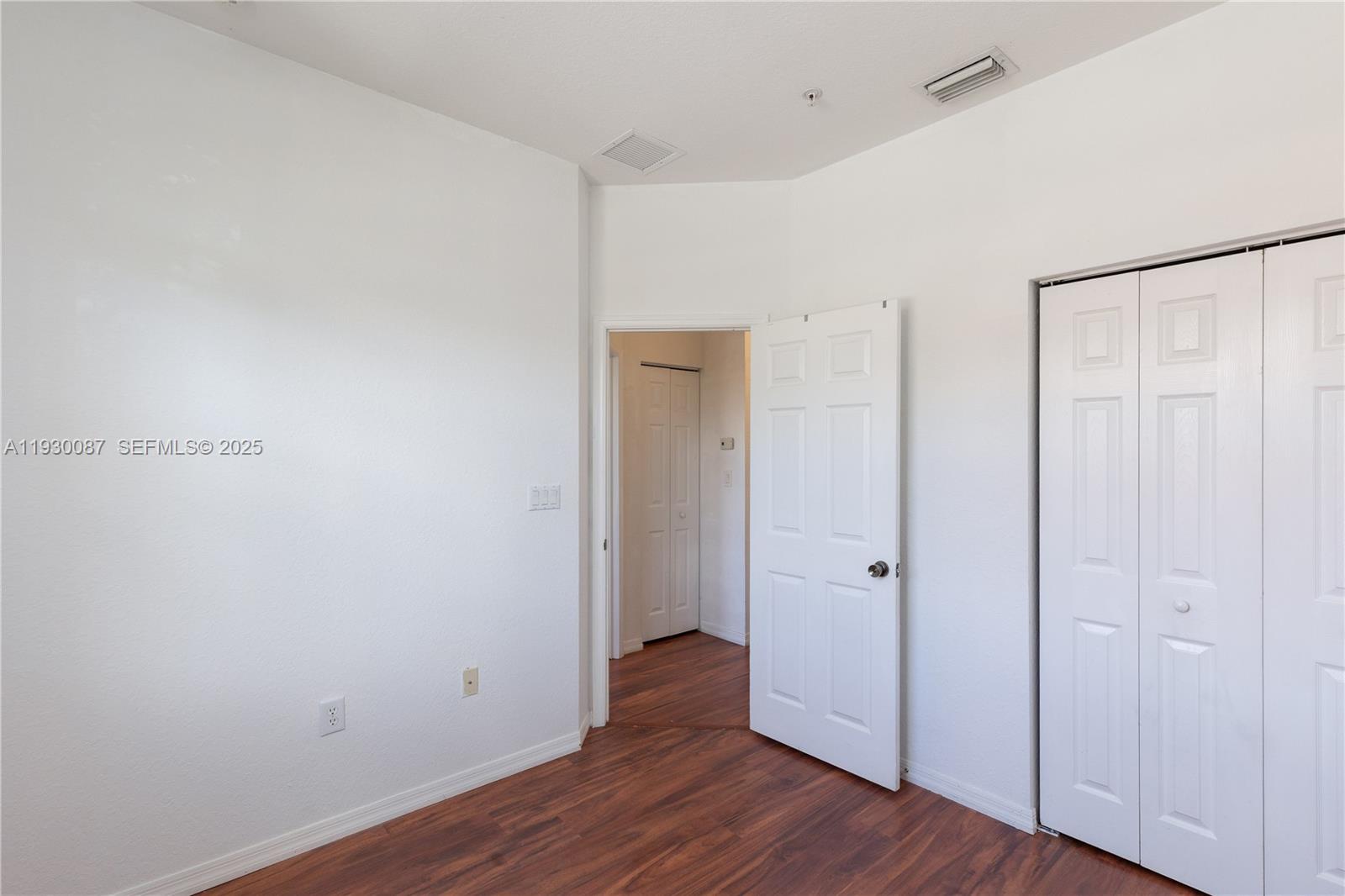 1009 Southwest 144th Avenue, Unit 2701 Pembroke Pines, FL 33027 - Photo 19 of 36 a view of an empty room with wooden floor