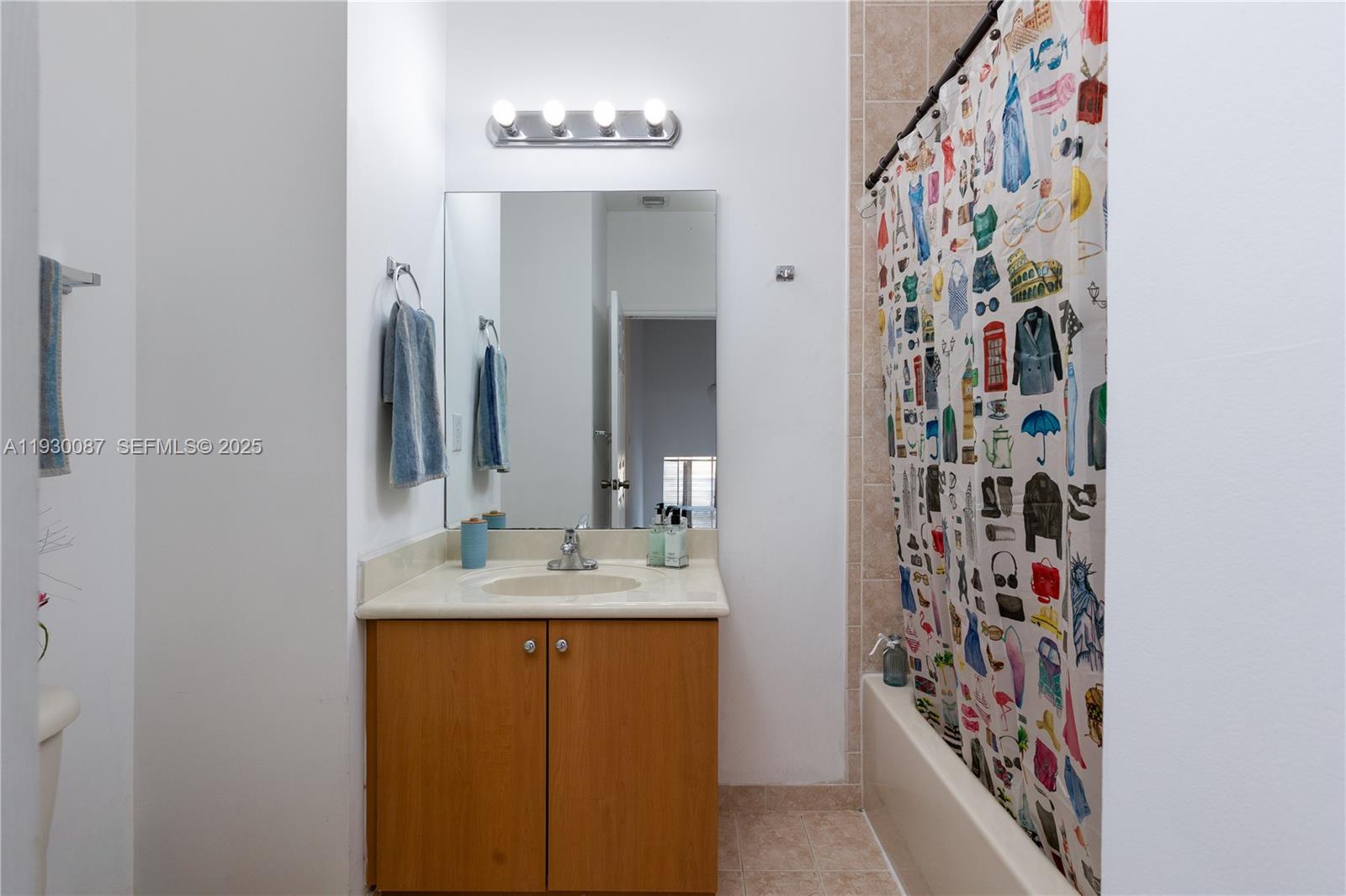 1009 Southwest 144th Avenue, Unit 2701 Pembroke Pines, FL 33027 - Photo 20 of 36 a bathroom with a sink and a mirror