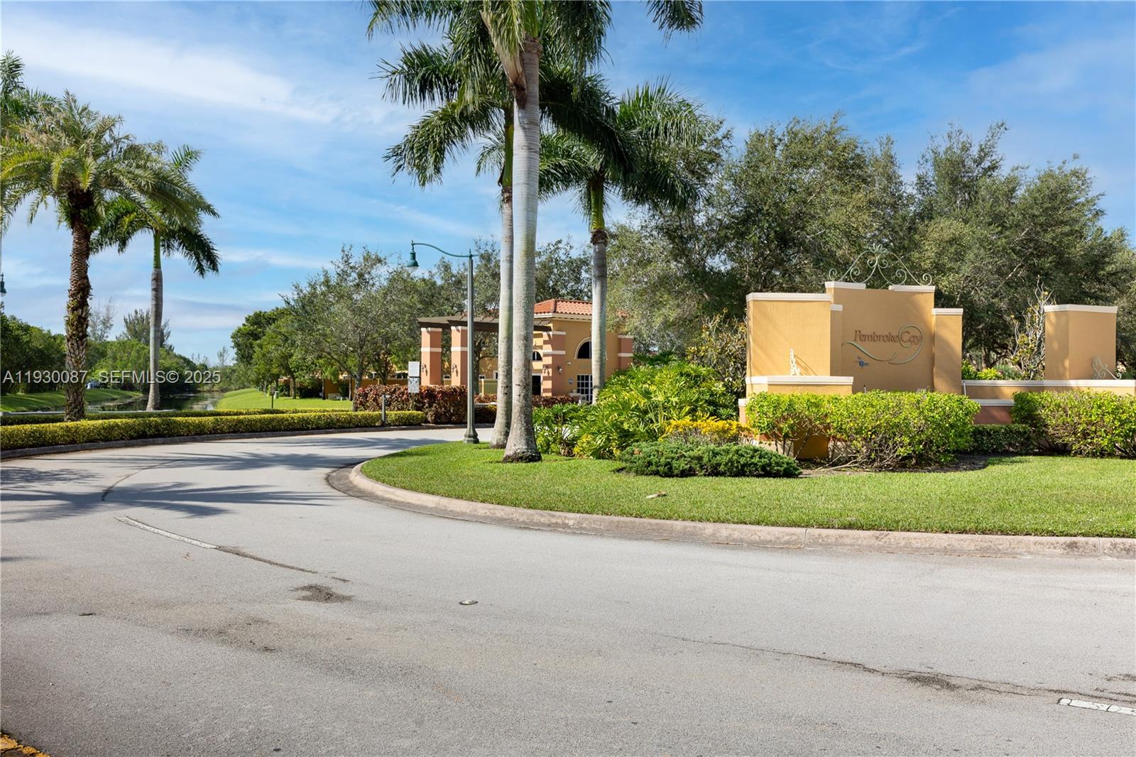 1009 Southwest 144th Avenue, Unit 2701 Pembroke Pines, FL 33027 - Photo 22 of 36 a front view of a house with a yard and palm trees