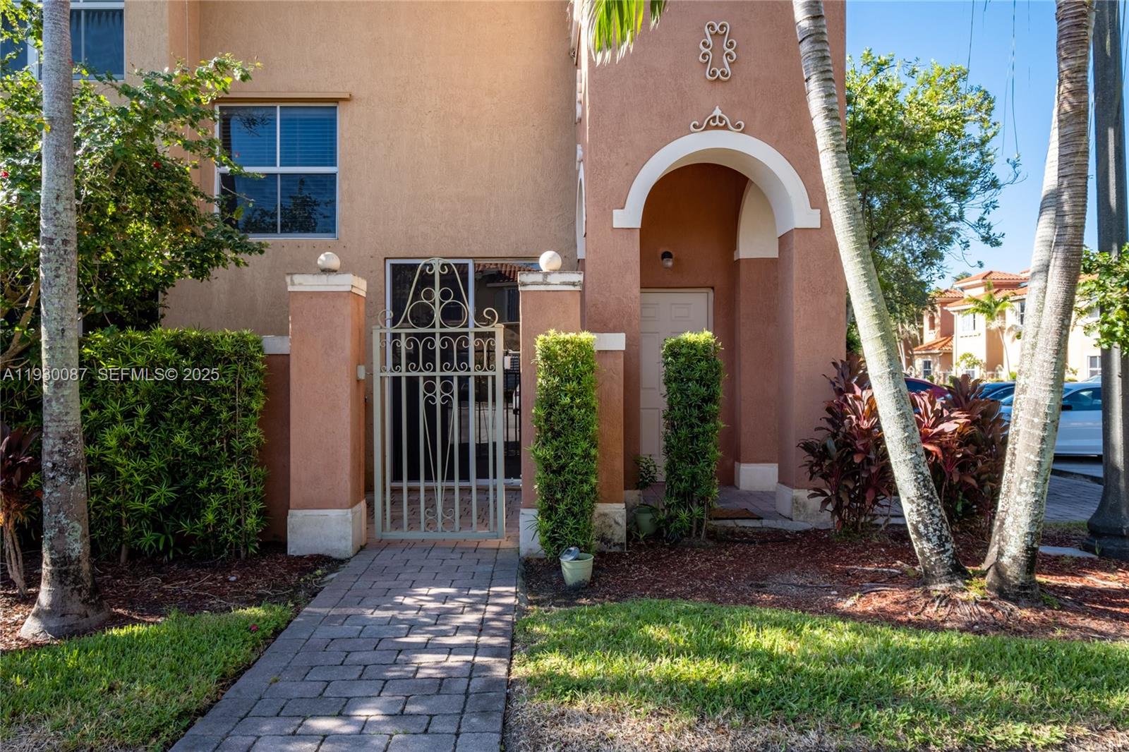 1009 Southwest 144th Avenue, Unit 2701 Pembroke Pines, FL 33027 - Photo 30 of 36 a front view of a house with garden
