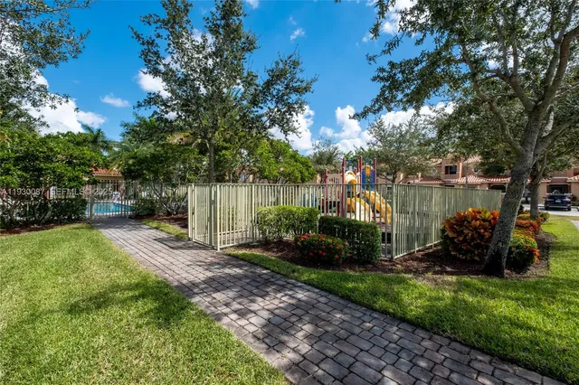 a view of a park with slide and a lake view