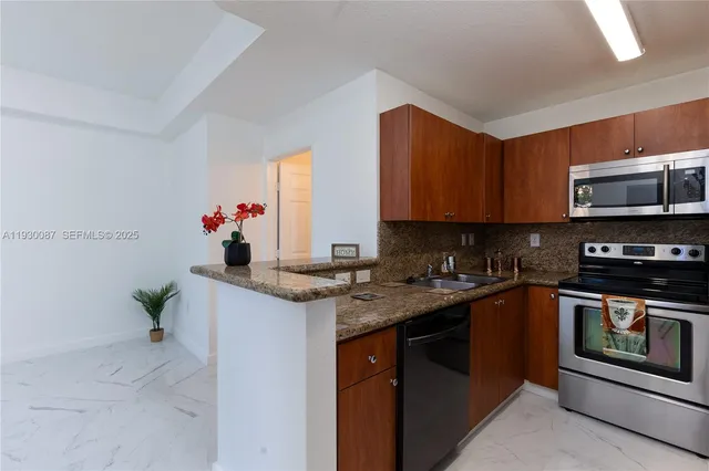 a kitchen with stainless steel appliances granite countertop a sink stove and refrigerator
