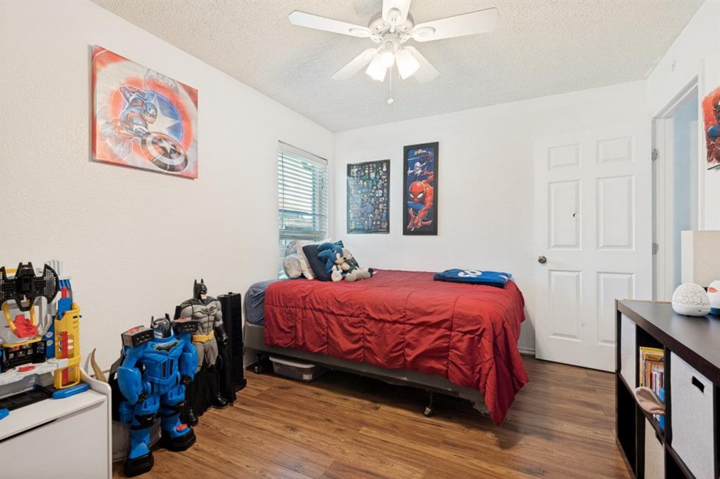 7410 Jessica Way Rowlett, TX 75088 - Photo 17 of 25 a bedroom with a bed and a chandelier