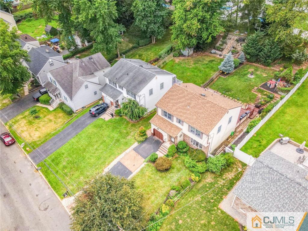 167 Kimberly Road Colonia, NJ 07067 - Photo 4 of 28 an aerial view of a house with a garden and swimming pool