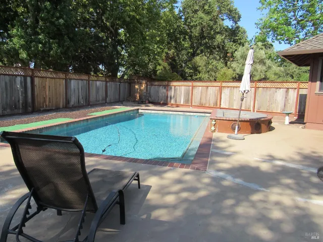 a swimming pool with wooden fence
