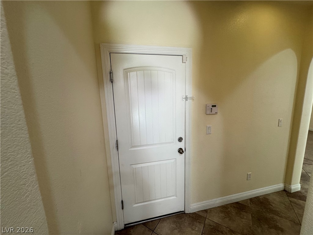 1333 Jamesbury Road Las Vegas, NV 89135 - Photo 11 of 43 A classic white interior door opens to a warm, inviting entry with durable tile flooring.