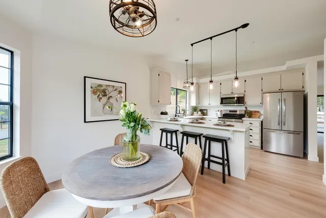 a dining room with furniture and a window