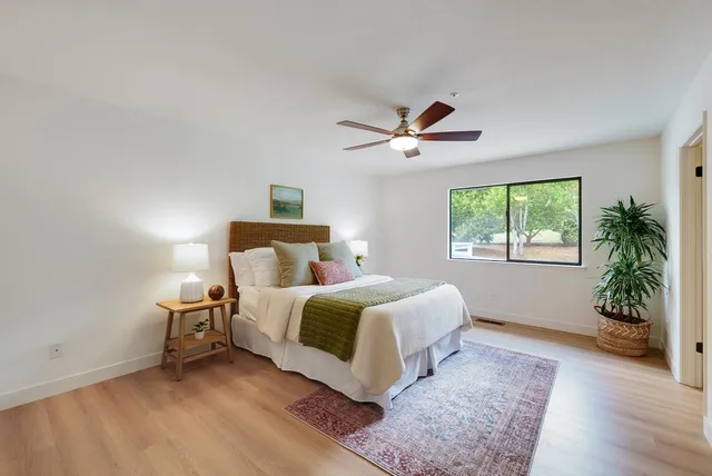 a bedroom with a bed and a window