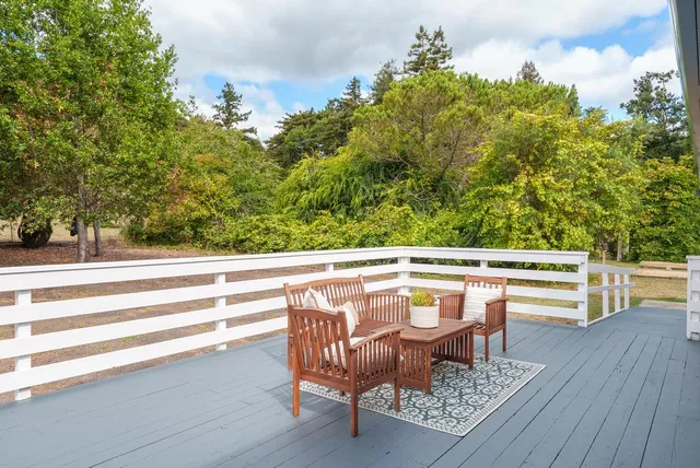 a view of a house with a yard and potted plants