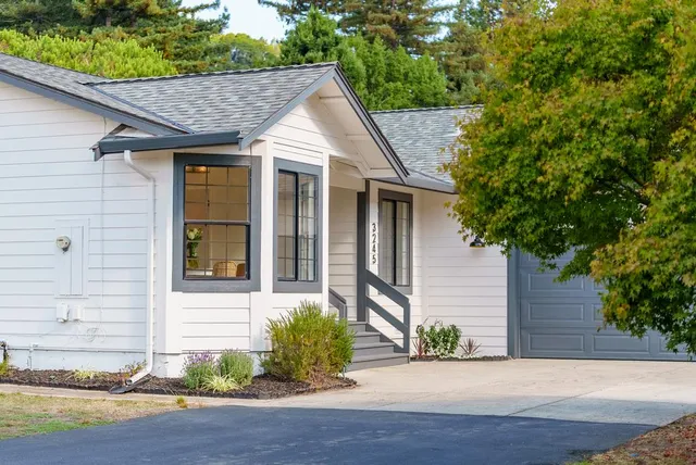 a front view of a house with garden