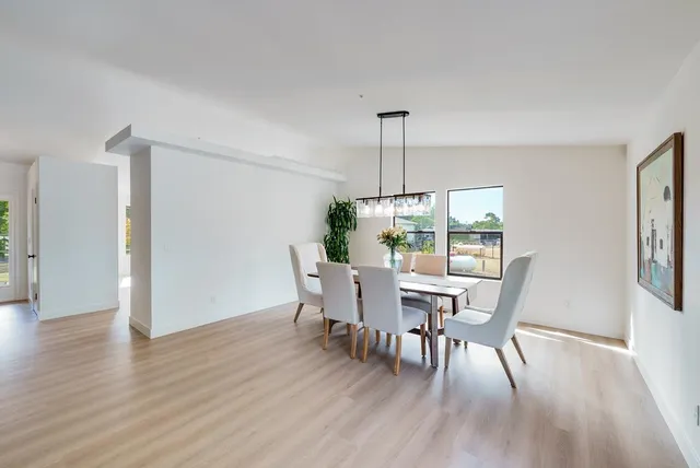 a view of a dining room with furniture window and wooden floor