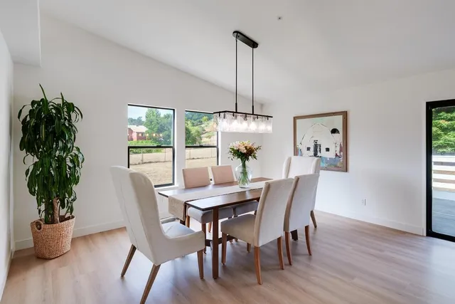 a view of a dining room with furniture window and outside view