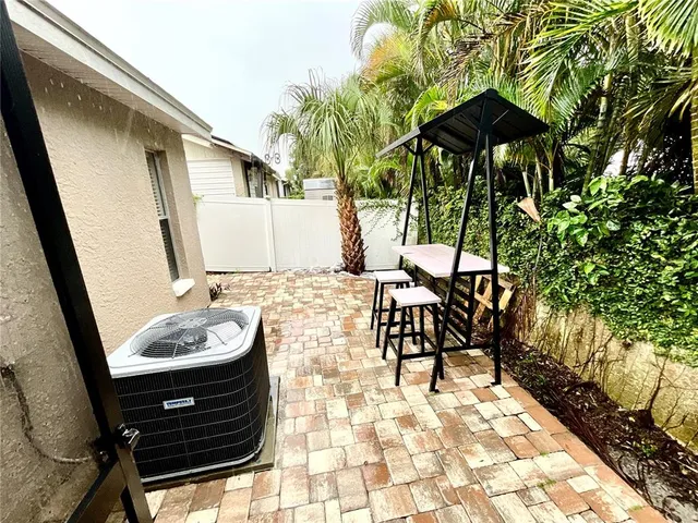 a view of a patio with chair and table of the backyard
