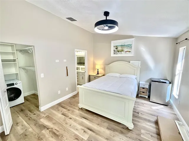 a bedroom with a bed and cabinets