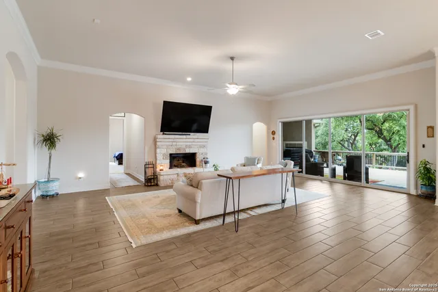 a living room with furniture a flat screen tv and a fireplace