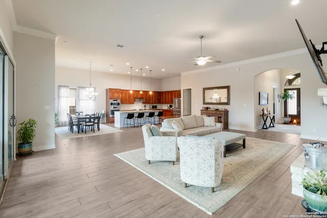 a living room with furniture and a view of kitchen