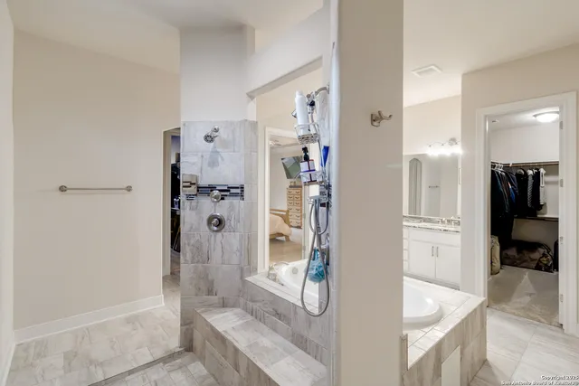 a bathroom with a bathtub and a shower