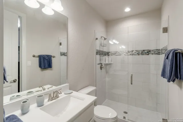 a bathroom with a sink toilet and shower