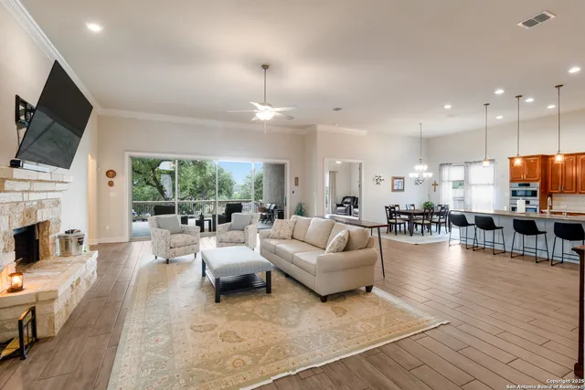 a living room with fireplace furniture and a flat screen tv