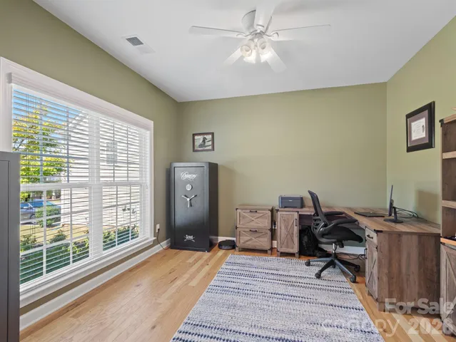 a workspace with wooden floor and a window