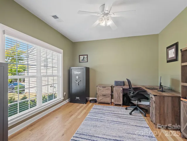 a workspace with wooden floor and a window