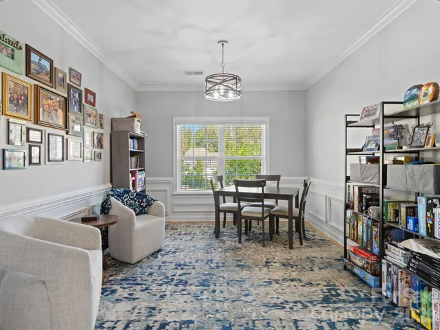 a dining room with lots of furniture and a book shelf