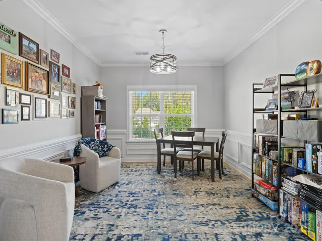 a dining room with lots of furniture and a book shelf