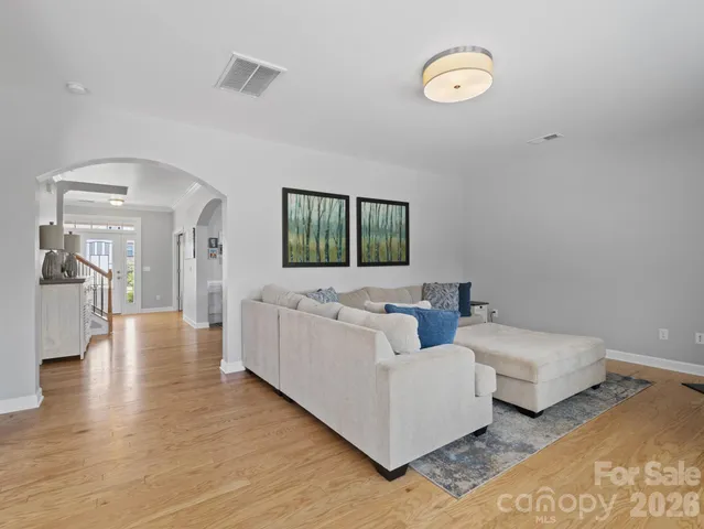 a living room with couches and a flat screen tv