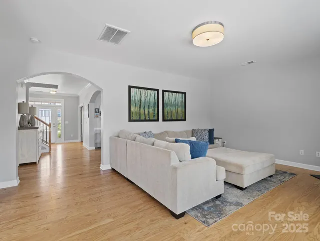 a living room with couches and a flat screen tv