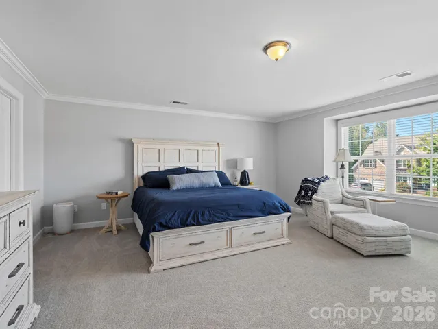a spacious bedroom with a bed and a couch