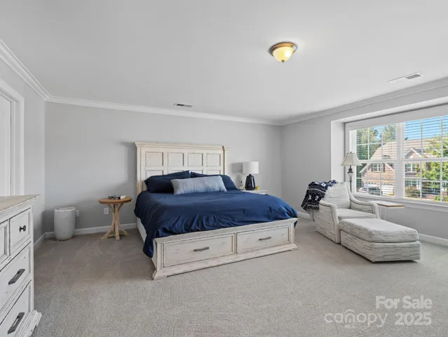 a spacious bedroom with a bed and a couch