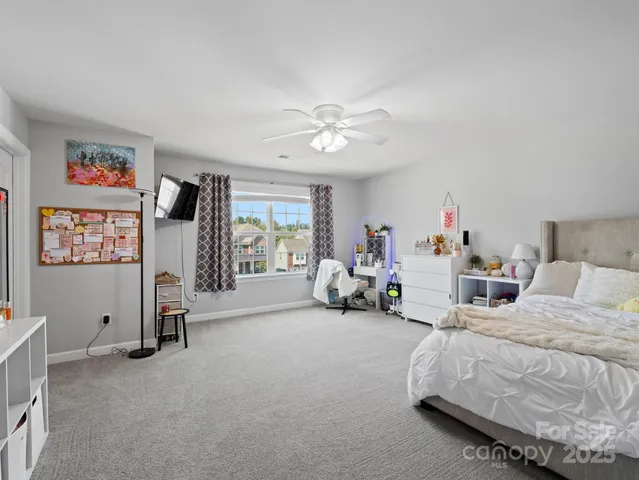 a bedroom with furniture and a flat screen tv