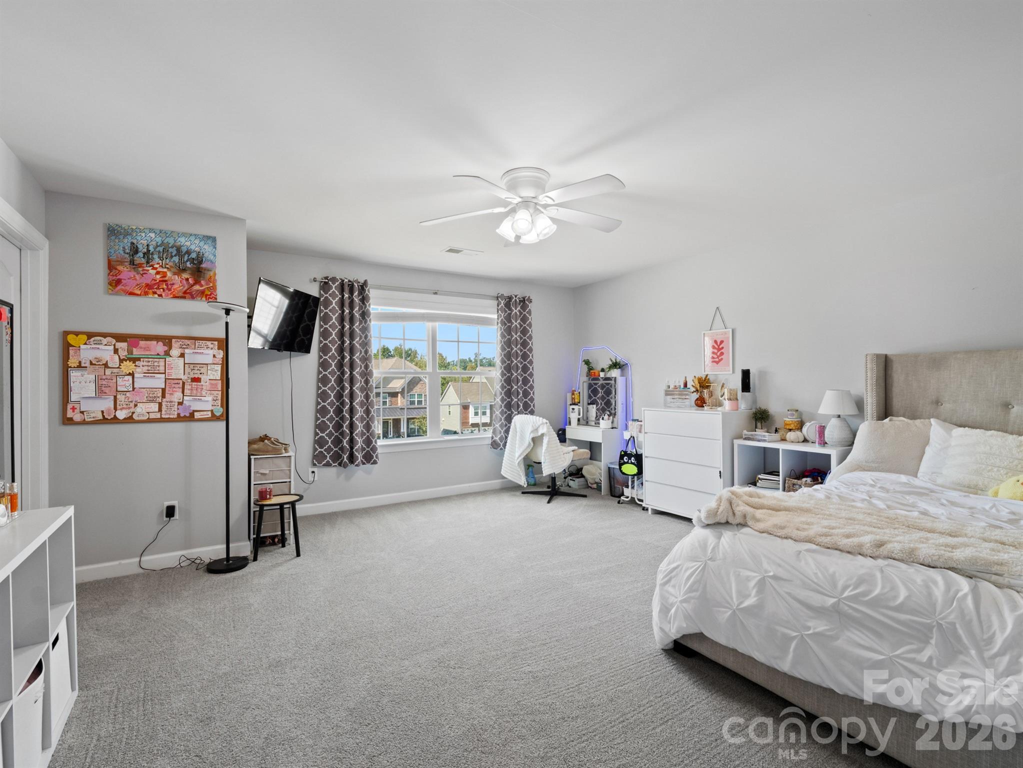 1982 Smokey Quartz Road Davidson, NC 28036 - Photo 27 of 43 a bedroom with furniture and a flat screen tv