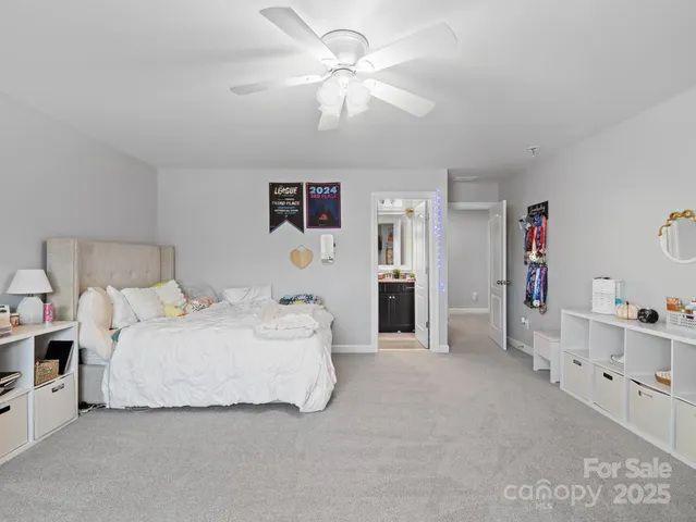 a spacious bedroom with a bed and a cabinets