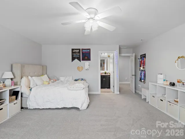 a spacious bedroom with a bed and a cabinets