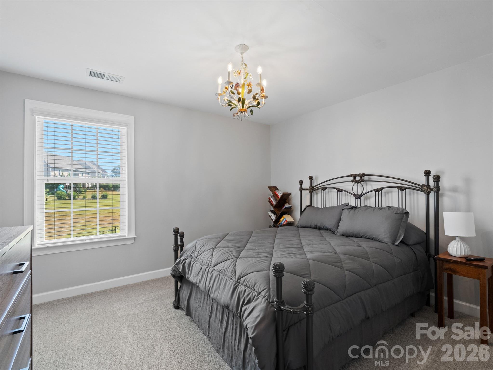 1982 Smokey Quartz Road Davidson, NC 28036 - Photo 30 of 43 a bedroom with a bed and a window