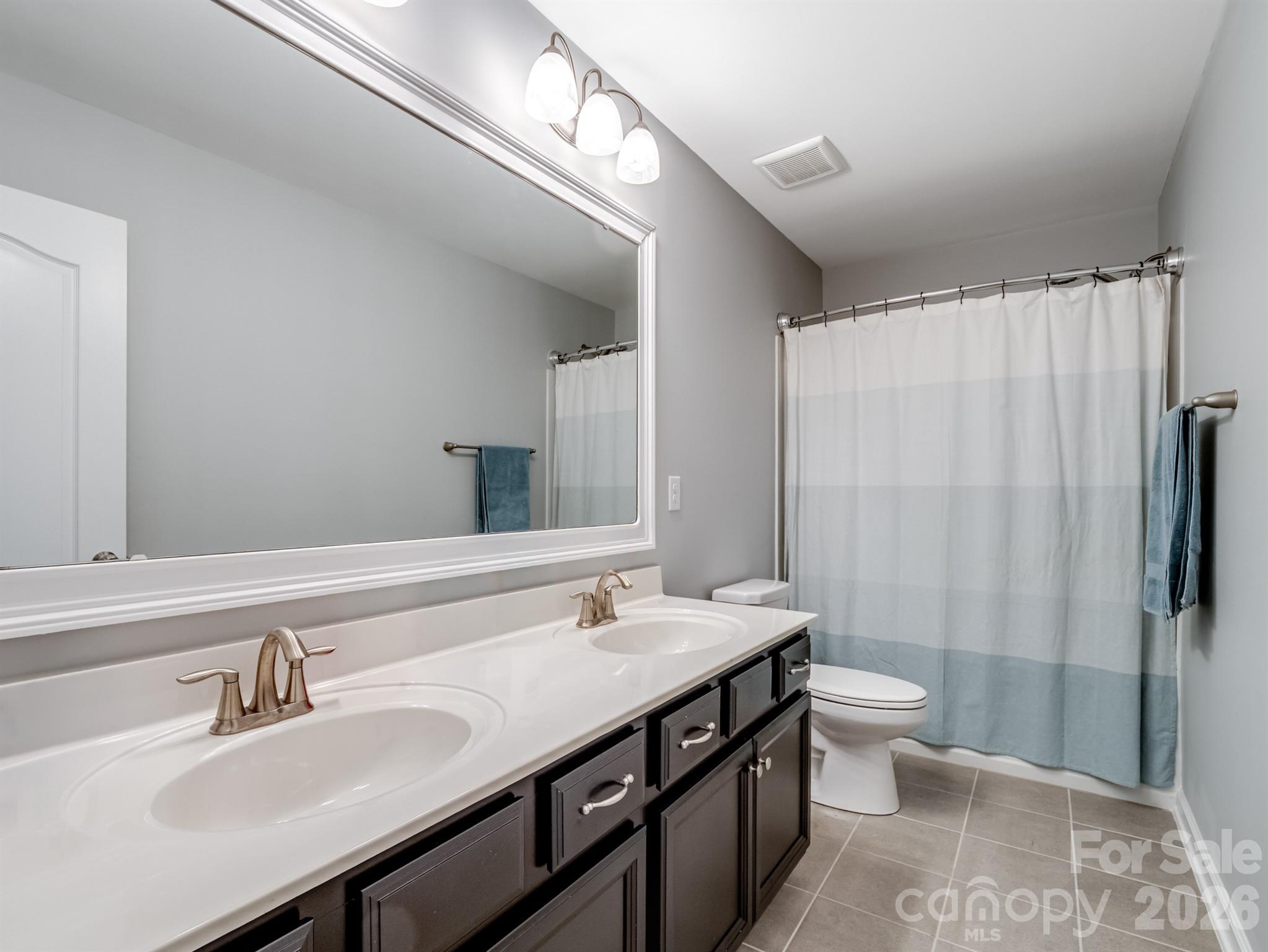 1982 Smokey Quartz Road Davidson, NC 28036 - Photo 32 of 43 a bathroom with a sink and a mirror