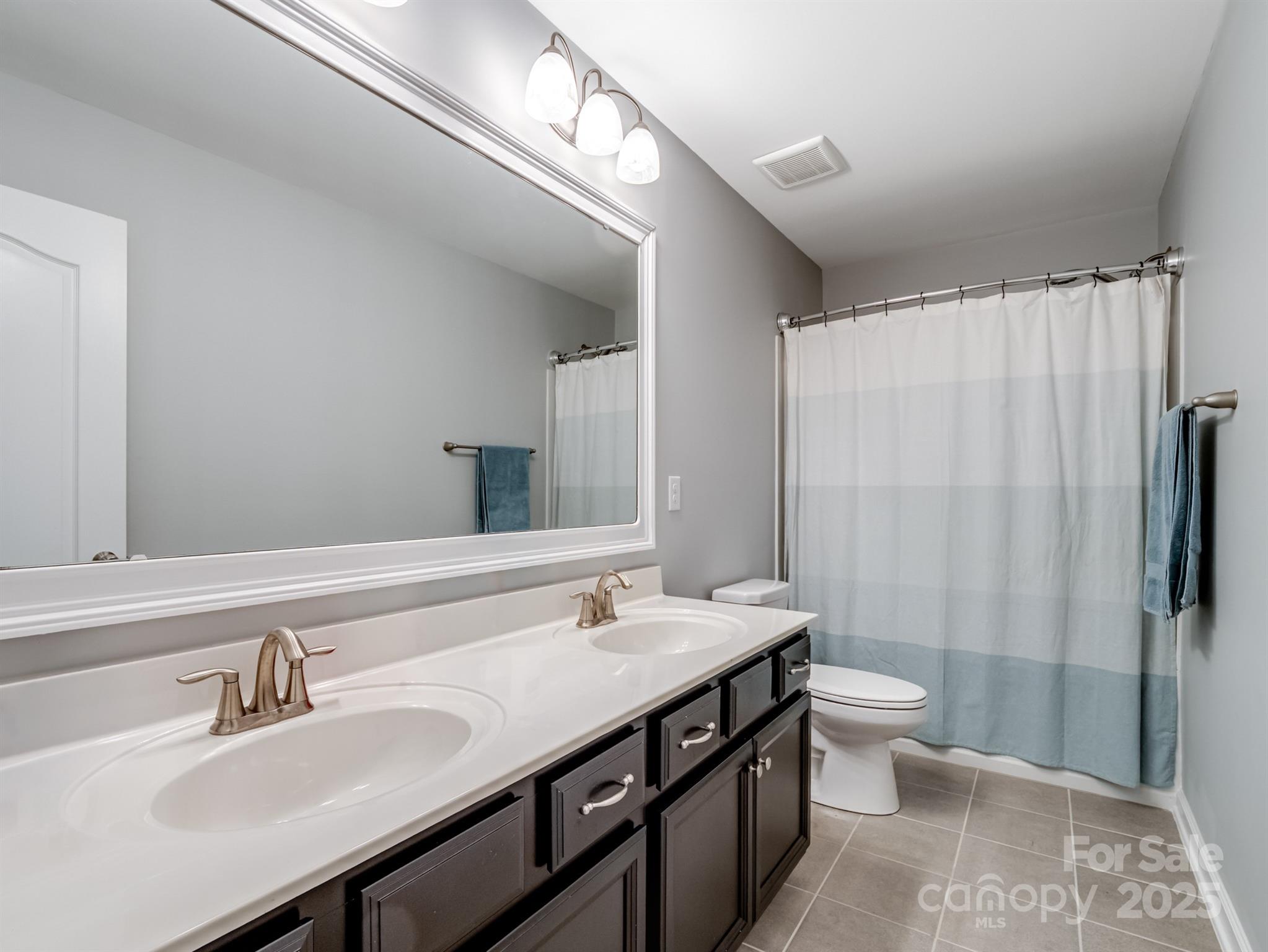 1982 Smokey Quartz Road Davidson, NC 28036 - Photo 32 of 43 a bathroom with a sink and a mirror