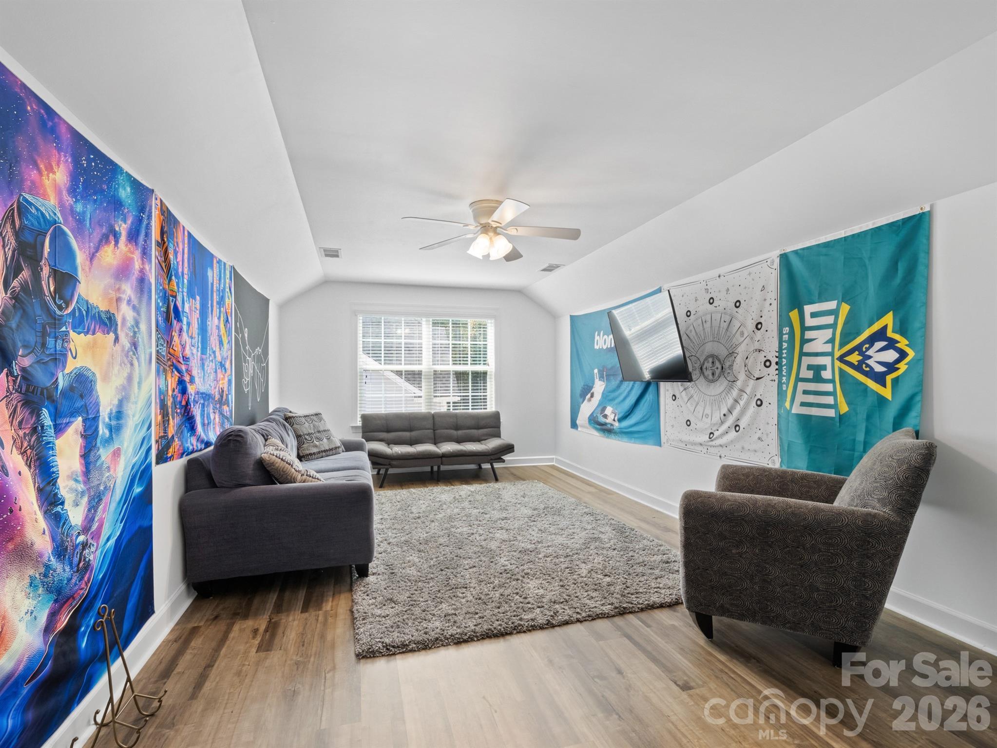 1982 Smokey Quartz Road Davidson, NC 28036 - Photo 34 of 43 a living room with furniture and a flat screen tv