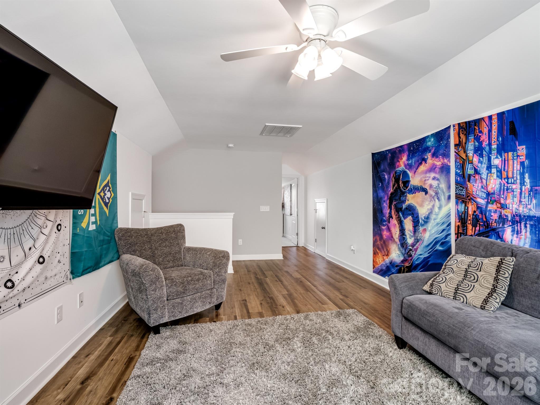 1982 Smokey Quartz Road Davidson, NC 28036 - Photo 35 of 43 a living room with furniture and a flat screen tv
